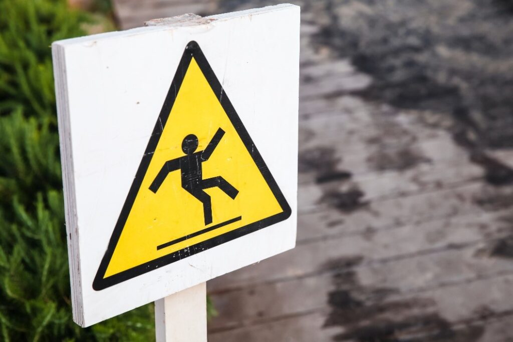 A caution sign illustrating a man falling